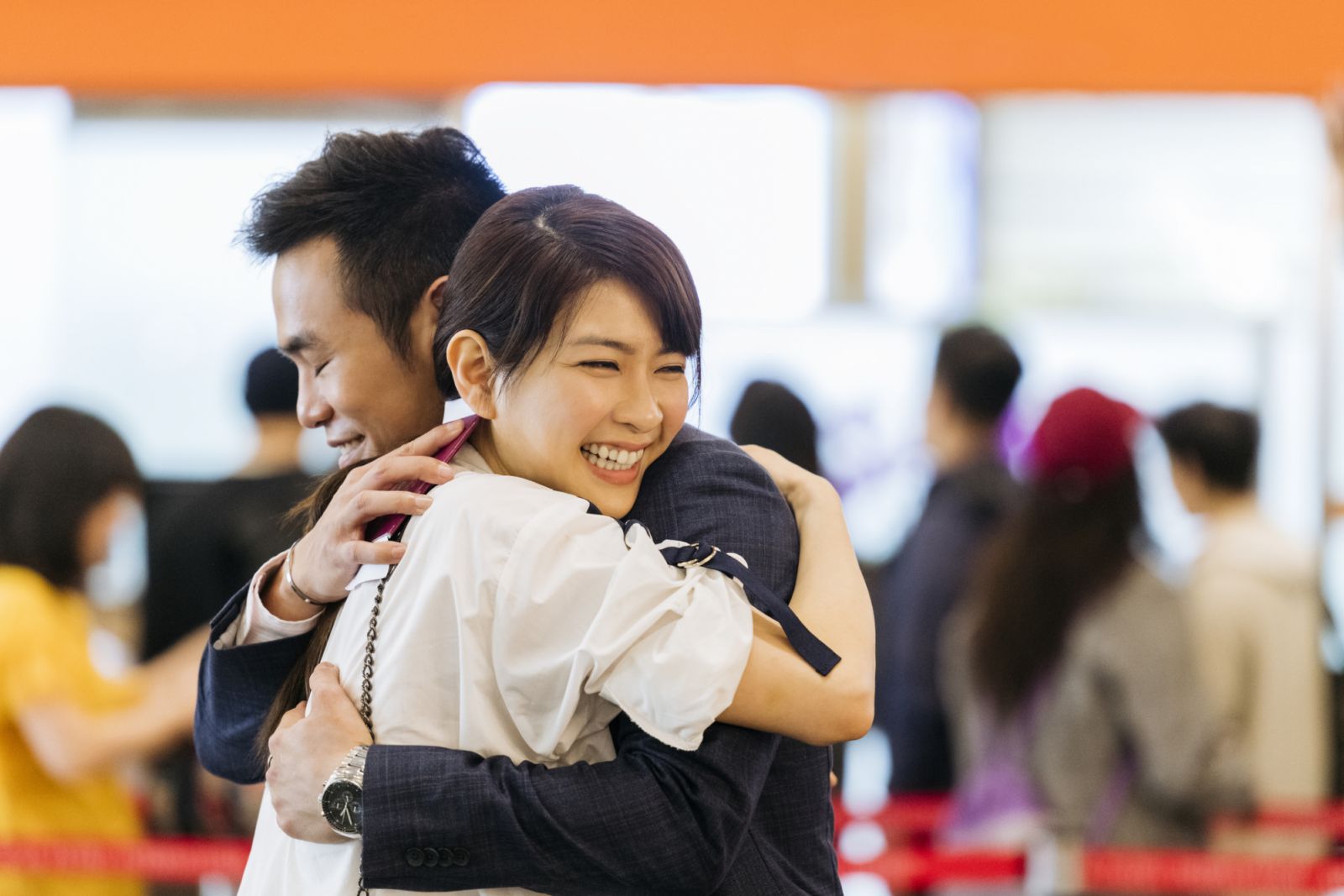 Cheerful man and woman hugging, reunion, love, togetherness