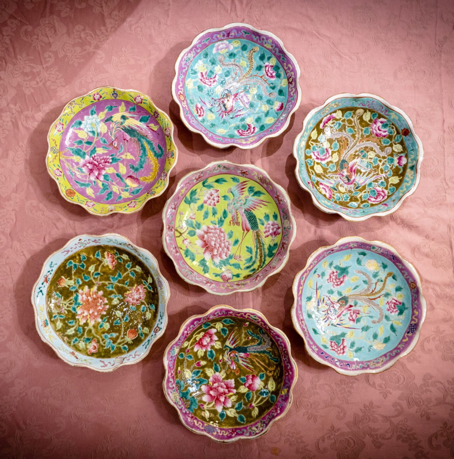 A selection of 9-inch lotus plates with traditional Nyonya patterns and symbols