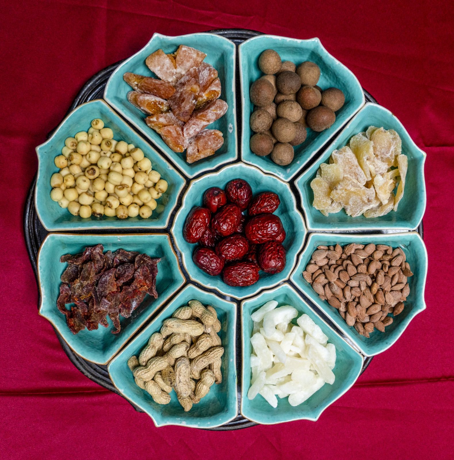 A 9-piece Chinese bonbonniere set comprising 8 segments around a centre bowl whose shape is derived from the lotus flower