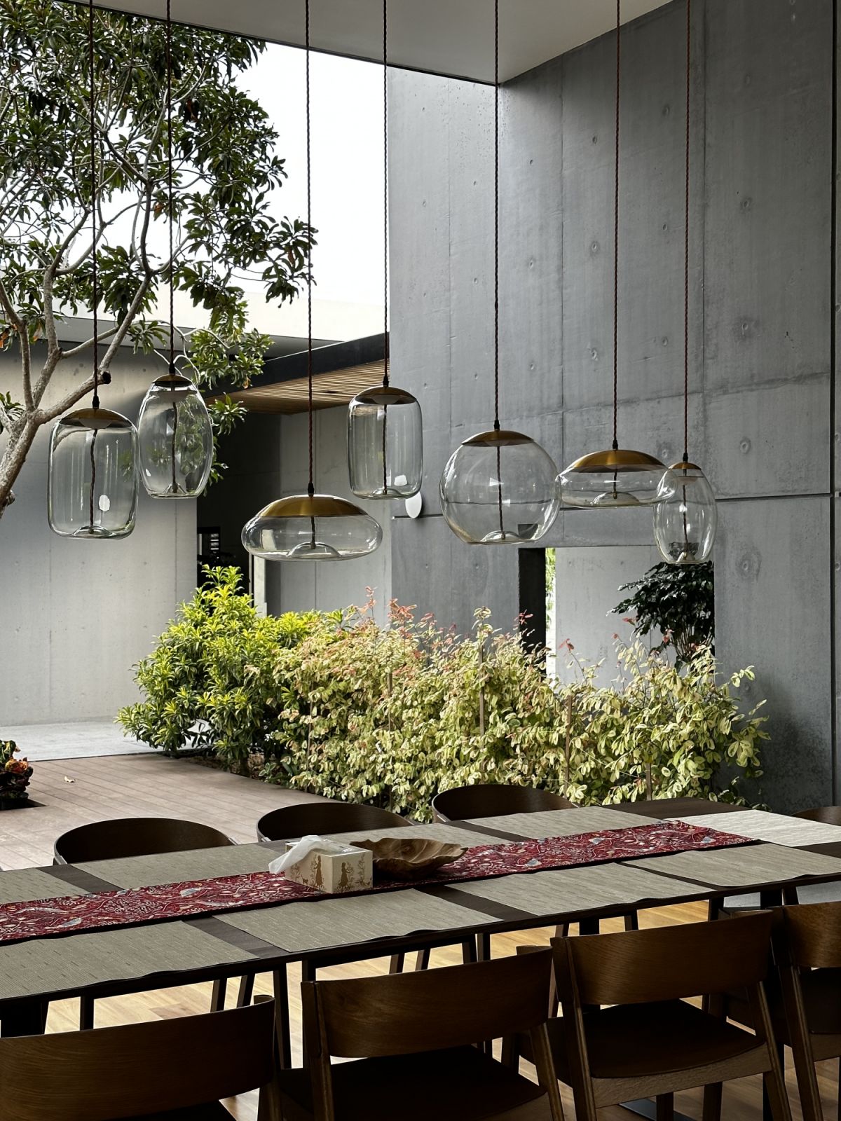 Hanging lights create a sculpture of sorts in the dining area