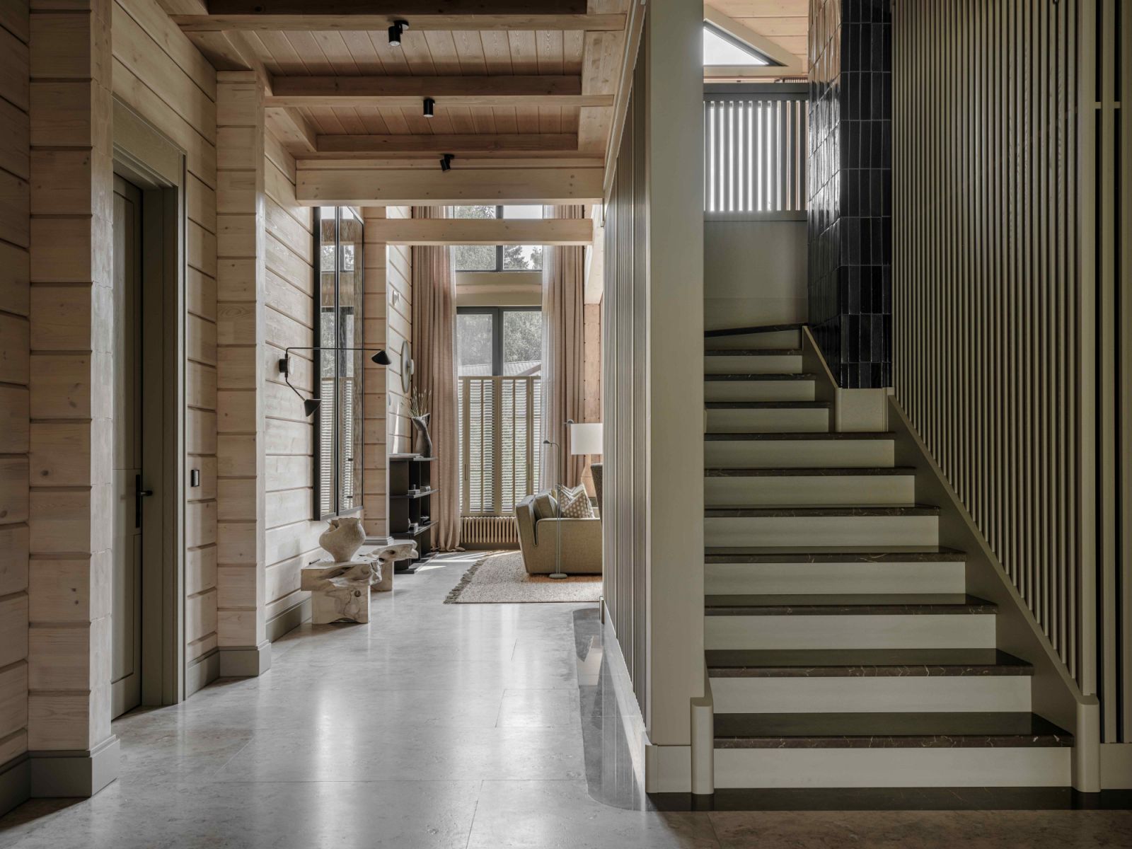 The “cube” staircase anchors the circular path that leads into the light-filled living room
