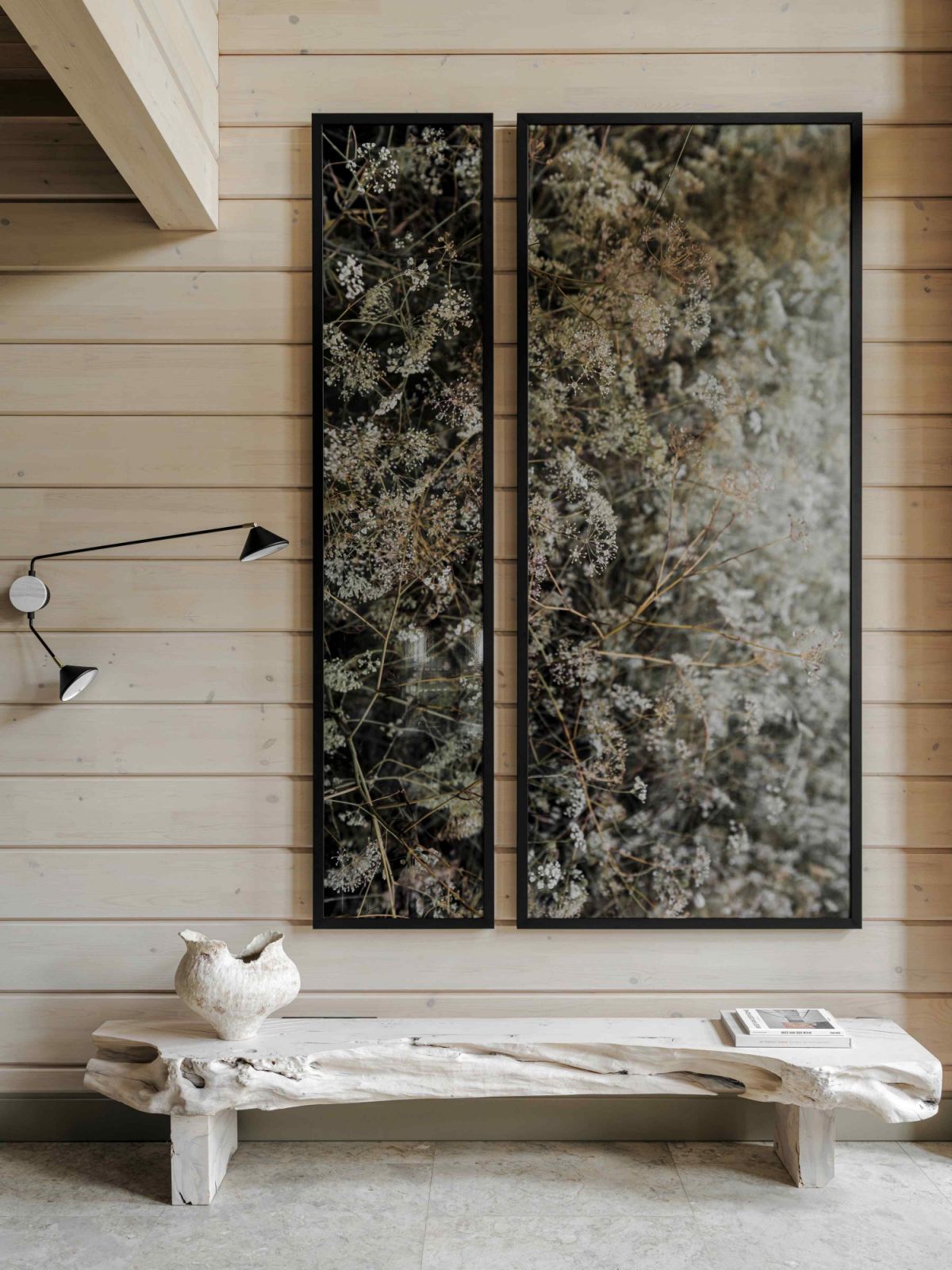 A wall-mounted diptych hangs above a bench made from hornbeam wood