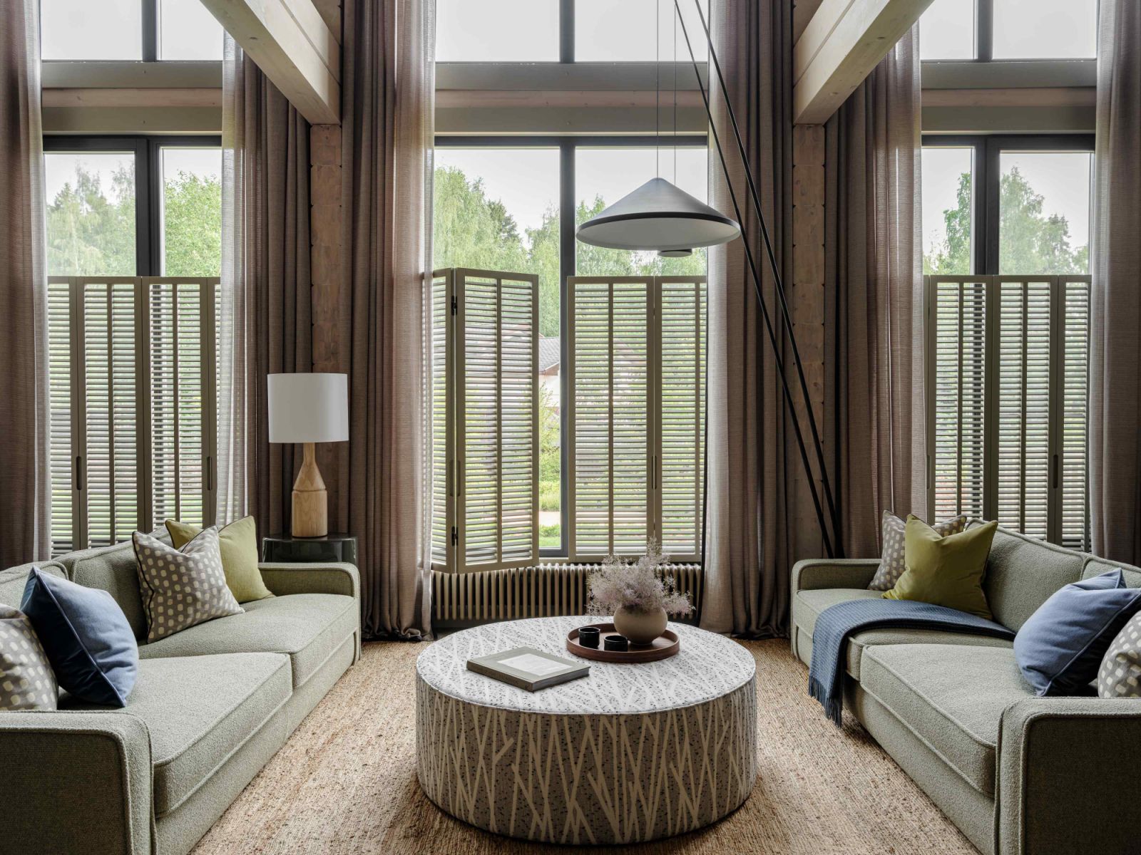 The wooden shutters offer privacy and views of the landscaped garden