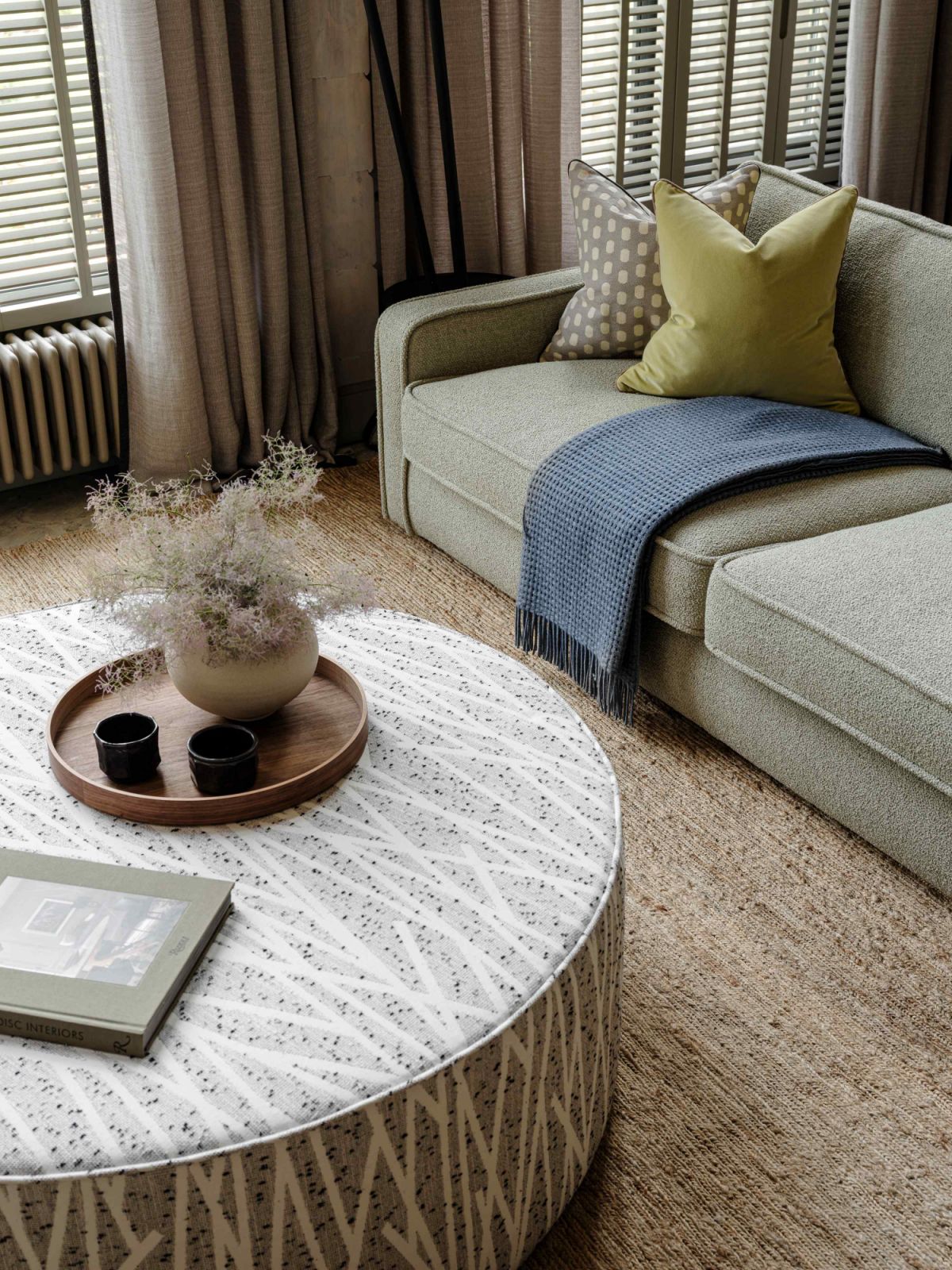 Custom-made furnishing in nature-inspired colours gives the room a softened edge