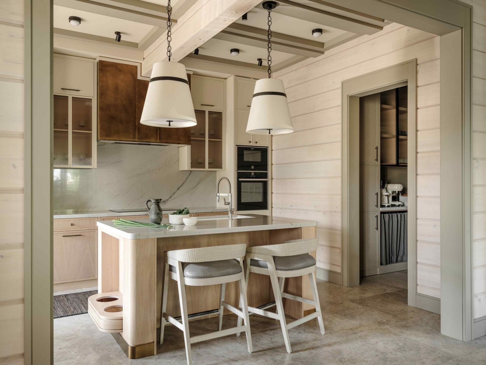 The communal space expands into the kitchens through a wide opening