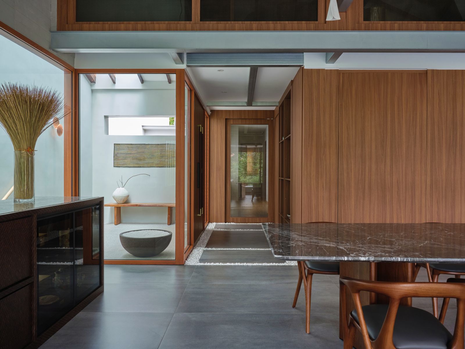 A view of the foyer separating the public and private zones, as well as the dining area located below the newly added mezzanine floor