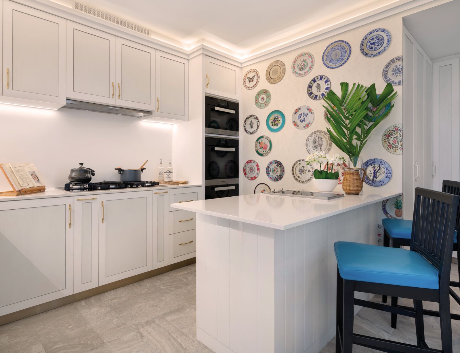 Wall-hung plates act as colourful conversation starters in the clean-lined kitchen