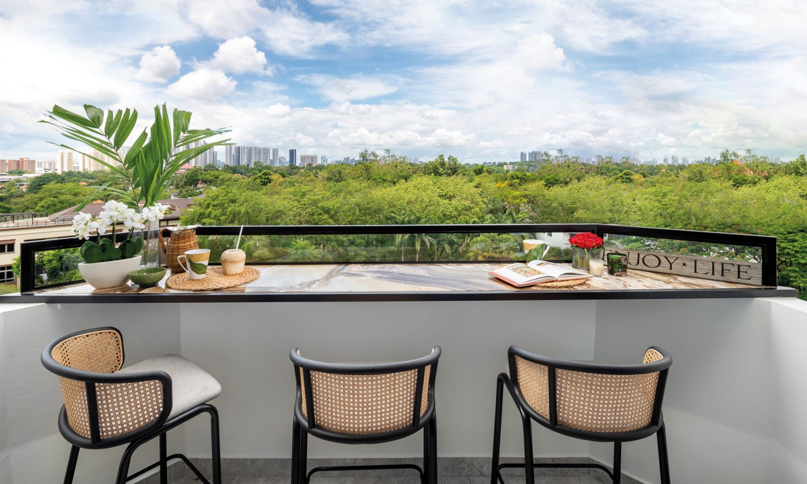 The outdoor countertop features a glass return to prevent accidental spills over the balcony