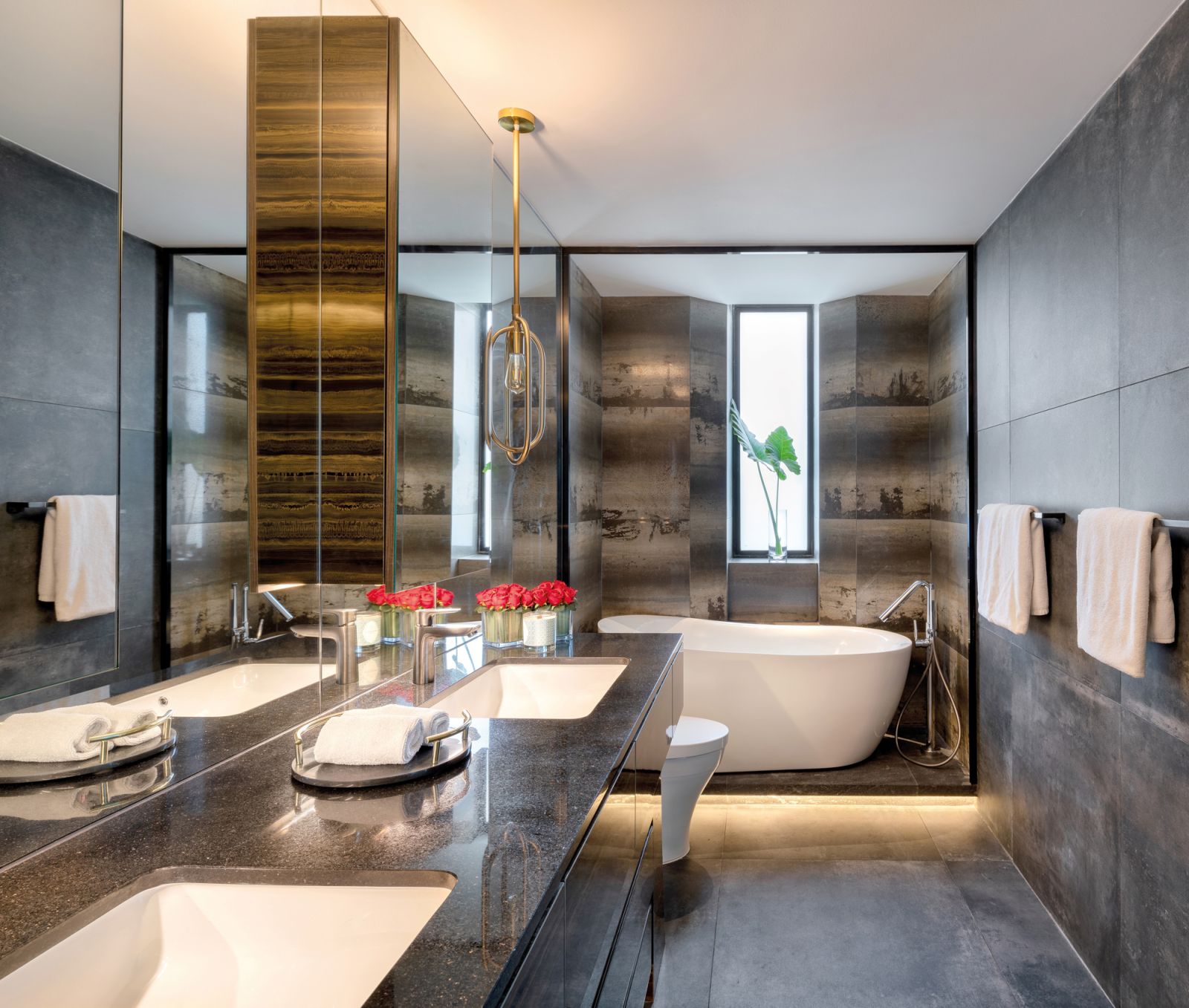 The master bathroom features soft backlighting for a relaxed, spa-like ambience