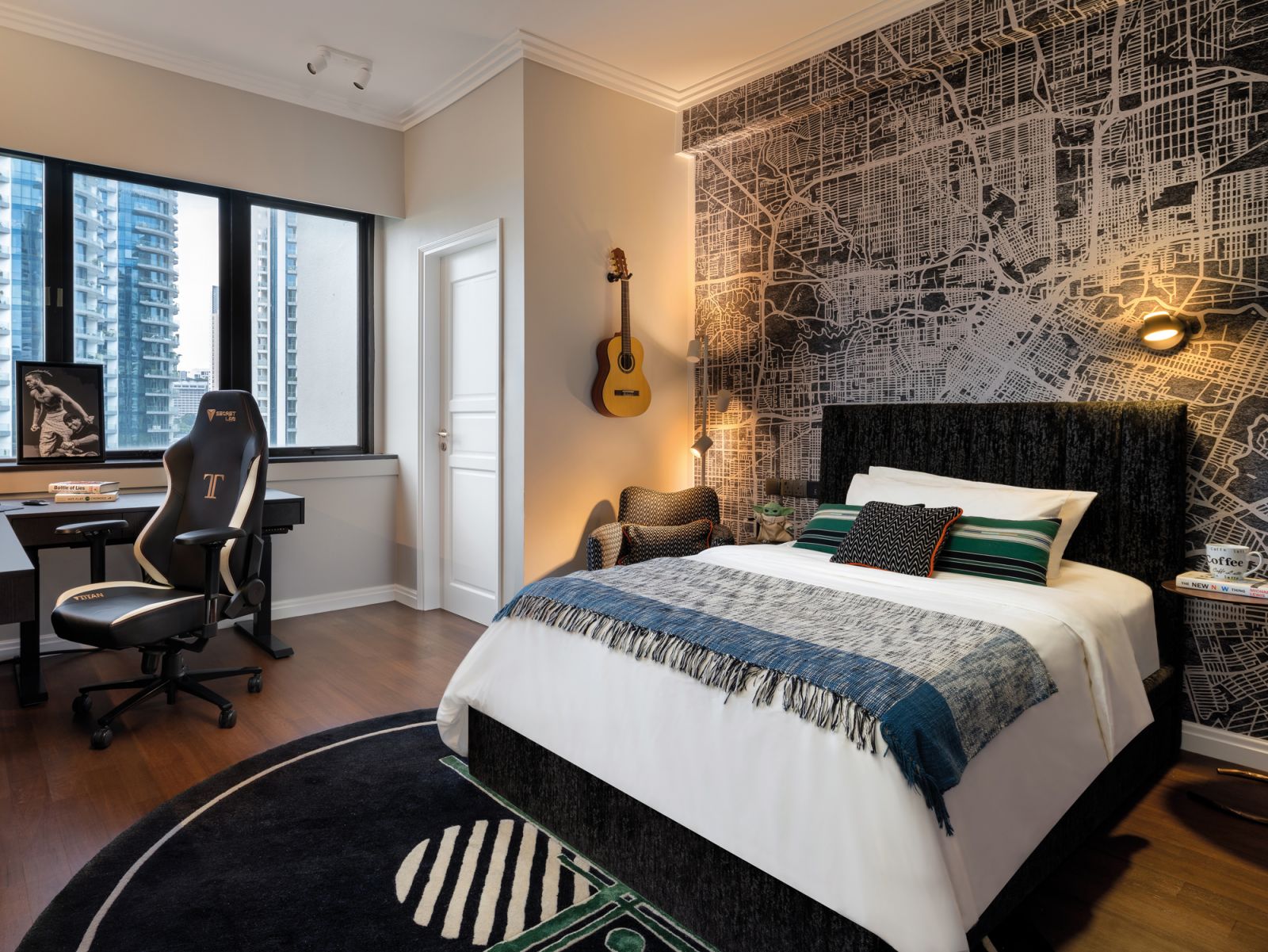 Accents of black, a wallpaper mural from Spanish brand Coordonne and a bespoke rug characterise the son’s subdued bedroom