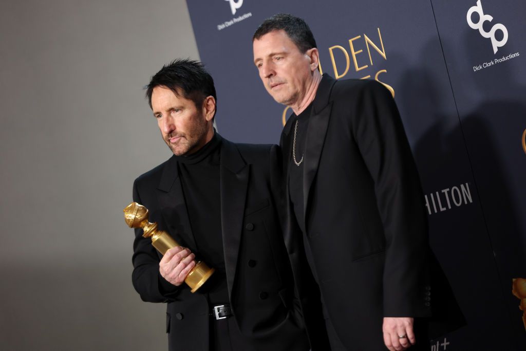 BEVERLY HILLS, CALIFORNIA - JANUARY 05: (L-R) Trent Reznor and Atticus Ross, winners of the Best Original Score – Motion Picture Award for "Challengers" pose in the press room during the 82nd Annual Golden Globe Awards at The Beverly Hilton on January 05, 2025 in Beverly Hills, California. (Photo by Matt Winkelmeyer/WireImage)