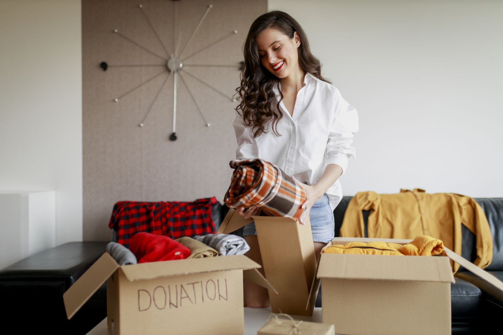 Sorting clothes into different boxes (Photo: Getty Images)