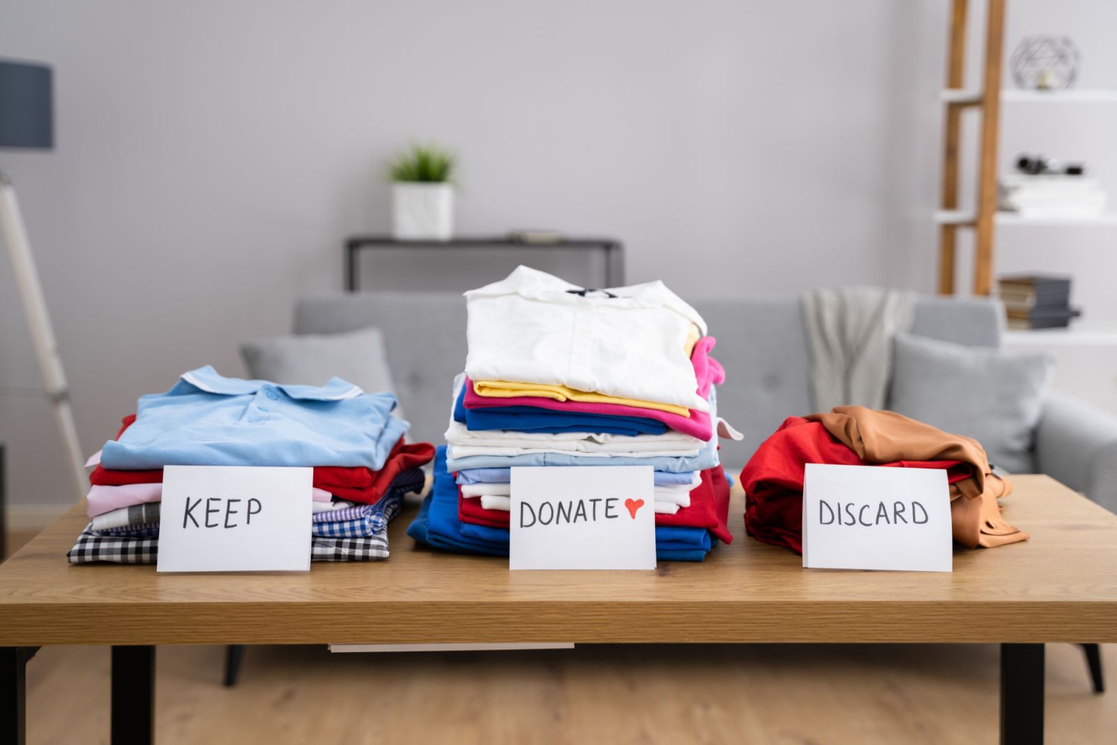 Sorting clothes into piles to keep, donate or discard (Photo: Getty Images)