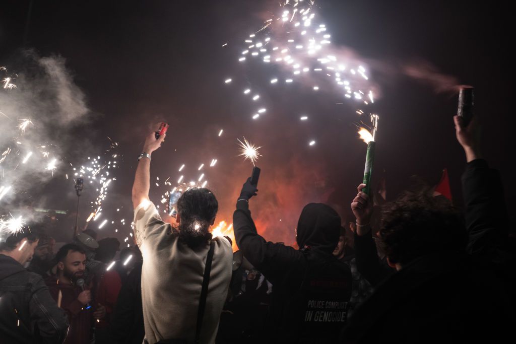 LONDON, ENGLAND - JANUARY 01: Pro-Palestine protestors let off flares at midnight on January 1, 2025 in London, England. Campaigners from the 'Countdown2Ceasefire' activist group are rallying amid New Year's celebrations in London to raise support for a permanent ceasefire in Gaza. (Photo by Guy Smallman/Getty Images)