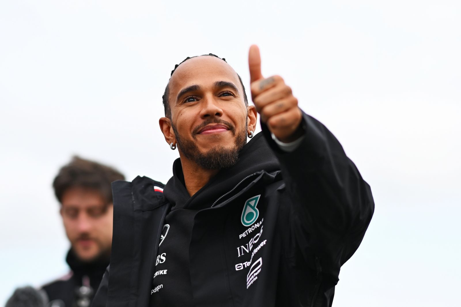 NORTHAMPTON, ENGLAND - JULY 04: Lewis Hamilton of Great Britain and Mercedes waves to the crowd from the track during previews ahead of the F1 Grand Prix of Great Britain at Silverstone Circuit on July 04, 2024 in Northampton, England. (Photo by Rudy Carezzevoli/Getty Images)