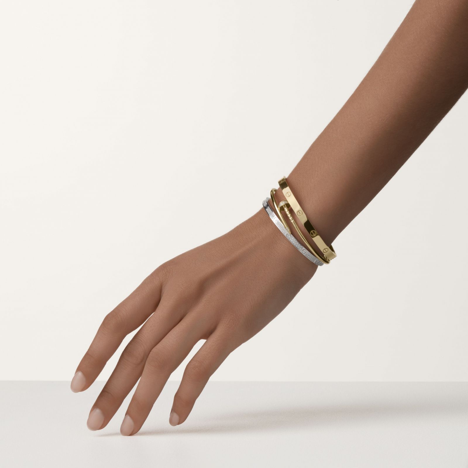 A woman's hand with Cartier bangles