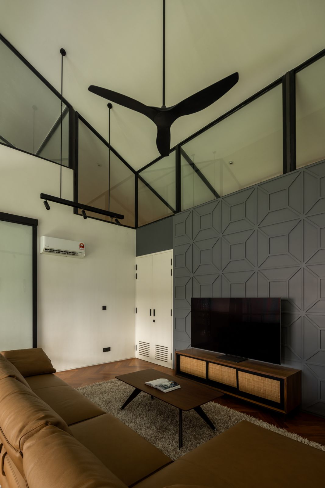 The family area’s high ceiling and geometric wall paneling create visual interest