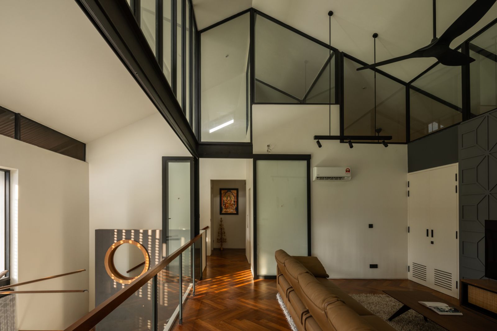 The family room showcases the staggered gable roof design that Kanny developed from the site’s trapezium shape
