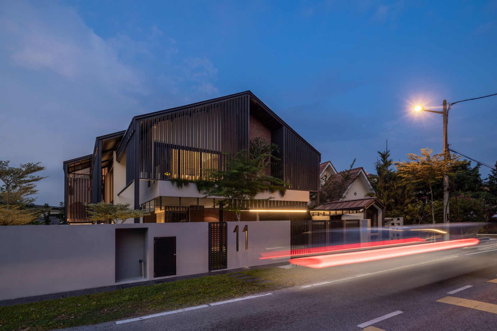 The exterior is a modern interpretation of traditional Malay Tebar Layar through vertical Chengal timber screens
