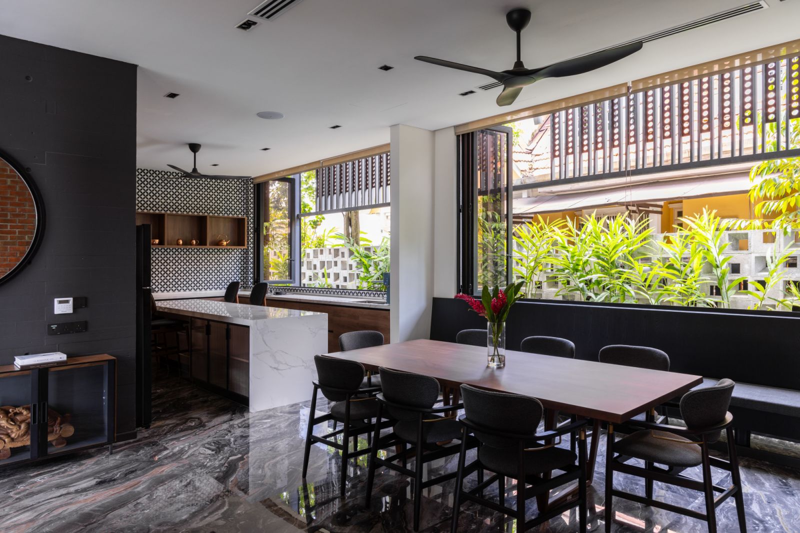 The dining area blends modern and traditional elements, with a marble counter and geometric tiles