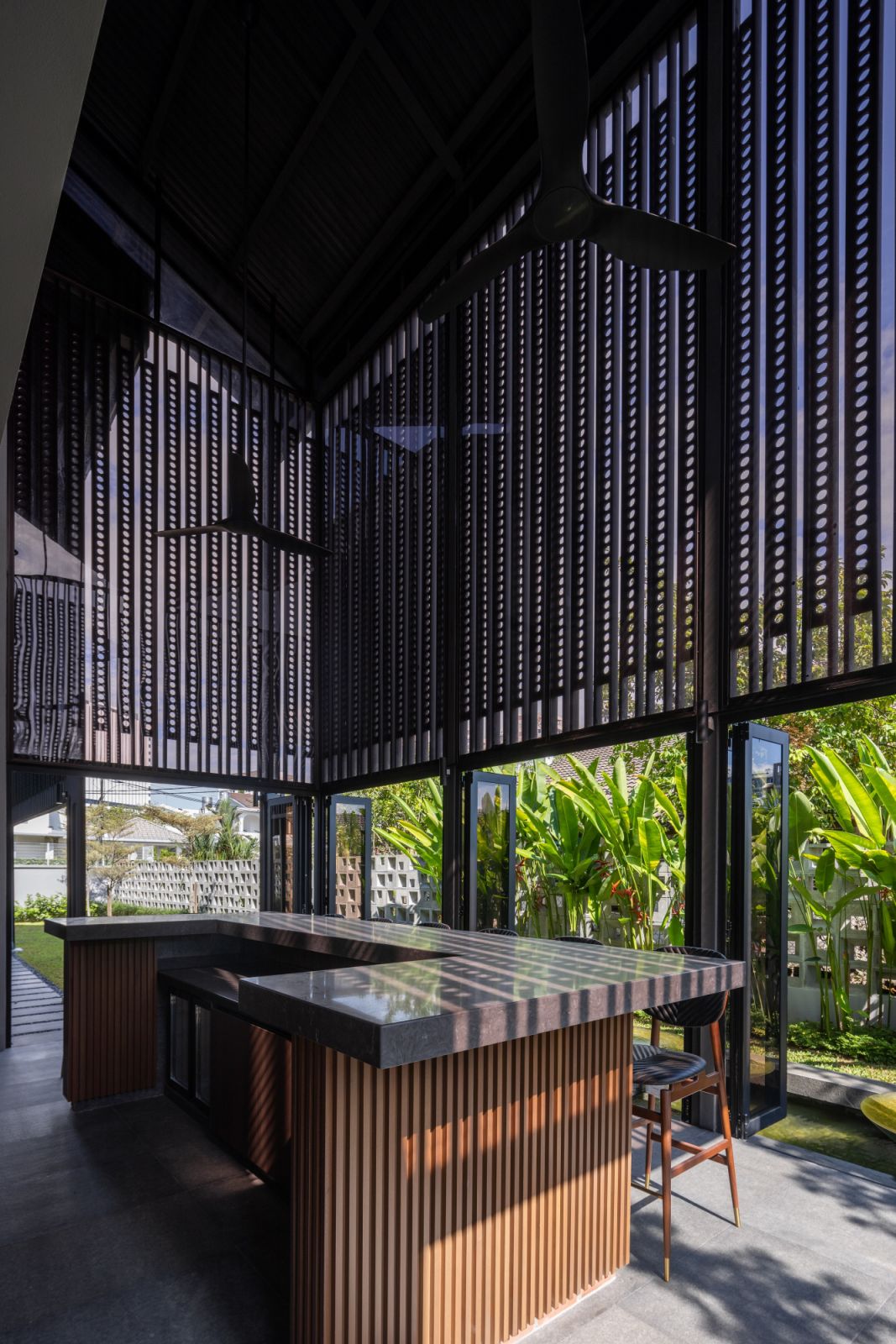 The bar area showcases the architect's modern interpretation of the traditional Tebar Layar ventilation system