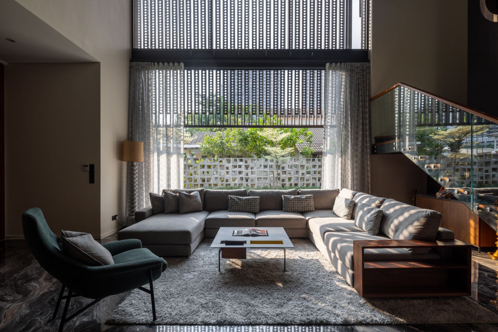 The living area opens to the garden through floor-to-ceiling windows