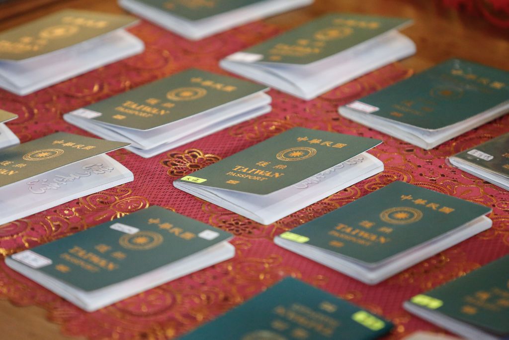 Indonesian immigration authorities are showing Taiwan national passports of detained Taiwanese individuals during a press conference at the Immigration Detention House in Jimbaran, Bali, Indonesia, on June 28, 2024. A total of 103 Taiwanese nationals are being detained and are going to be deported for allegedly committing cybercrime by Indonesian immigration officers and police at a villa in Tabanan, Bali, on June 26, 2024. (Photo by Johanes P. Christo/NurPhoto via Getty Images)