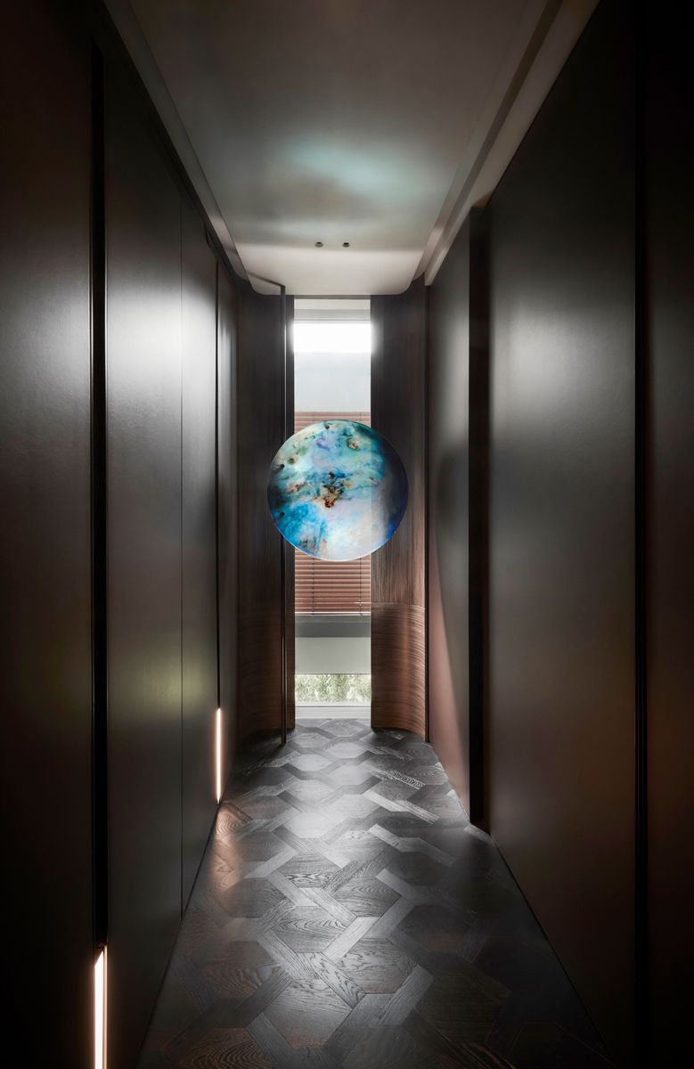 A custom artwork with rotatable mount by Wyn-Lyn Tan titled 'Opalescence VIII' is installed at the end of the elevator vestibule