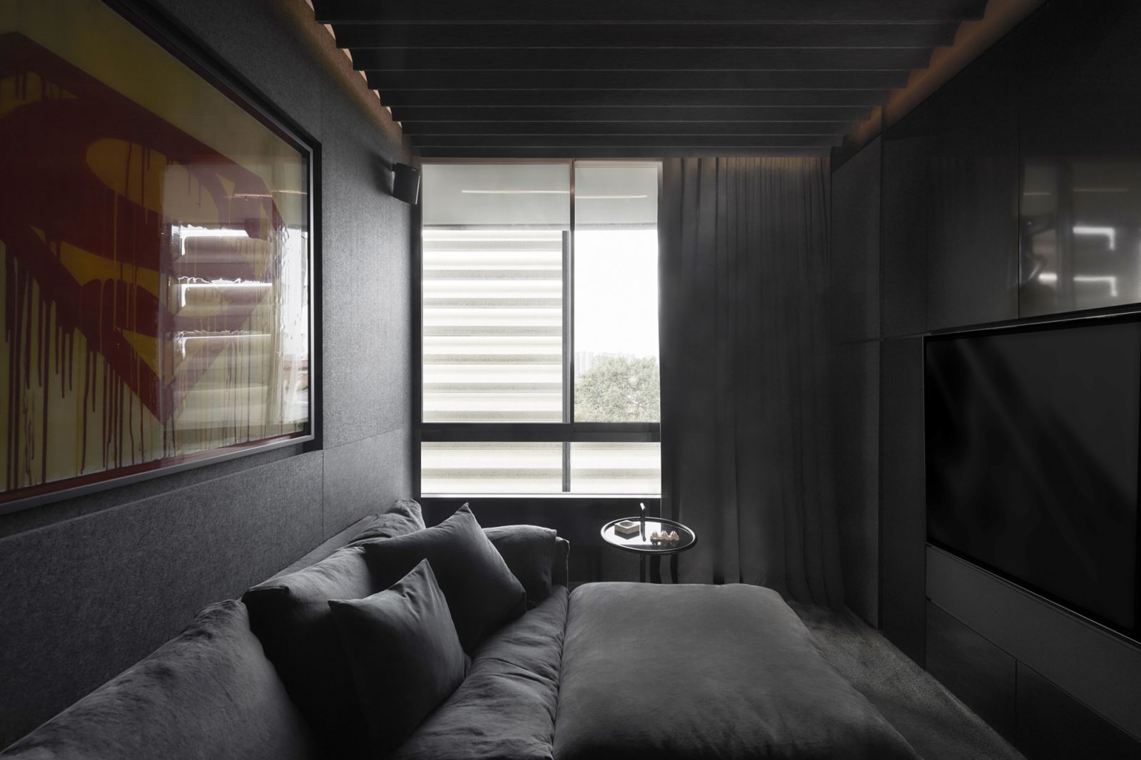 The screening room is hidden behind the whiskey bar, on the wall is an untitled Superman logo artwork by French graffiti artist Ceet Fouad commissioned by the homeowner via Gallery Reis