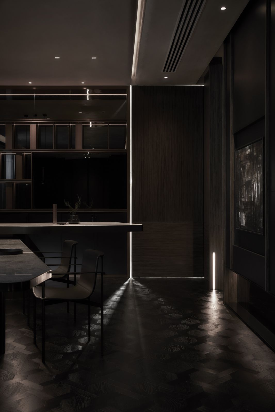 Slivers of light become a poetic brush that paints the all-dark Japanese-inspired home into reality