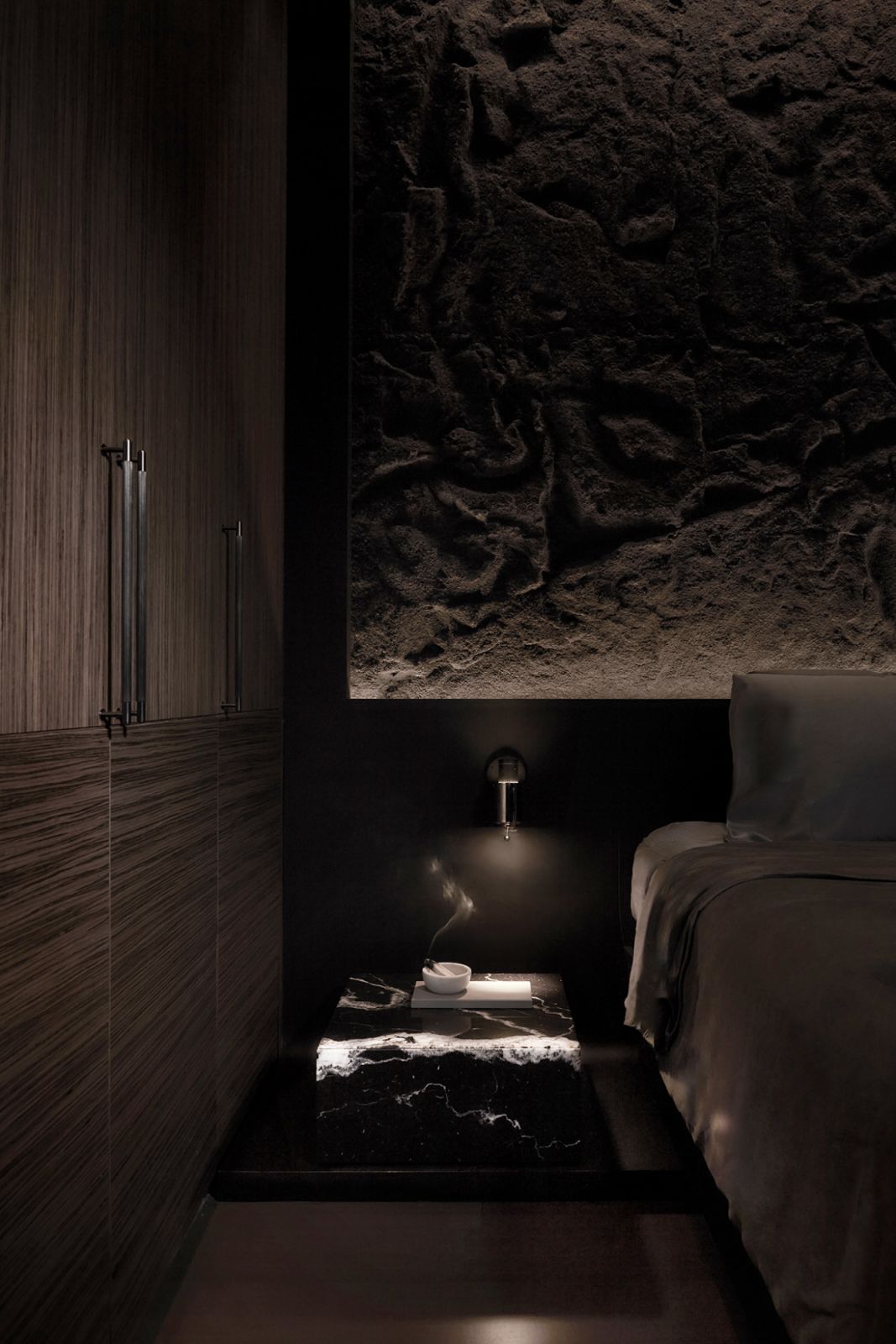 Textural wall lends a distinct counterpoint to the sleek material palette