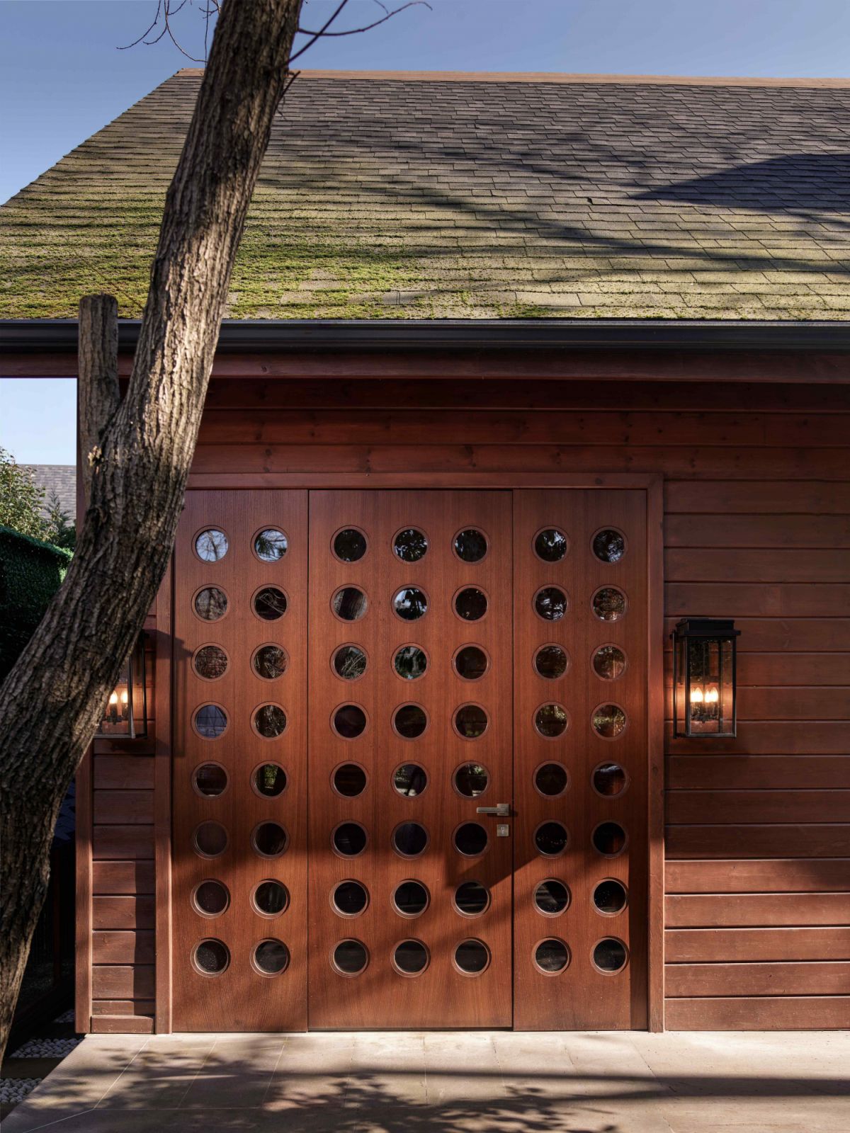 The perforated wood panels that make up the front entrance door