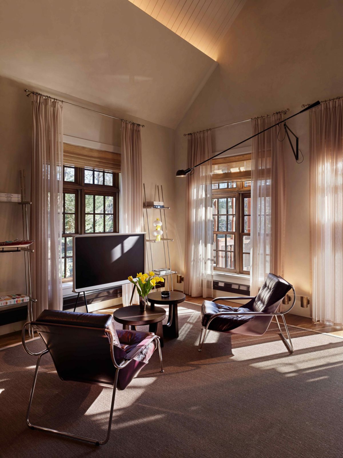 The TV area features stylish lounge chairs by Zanotta