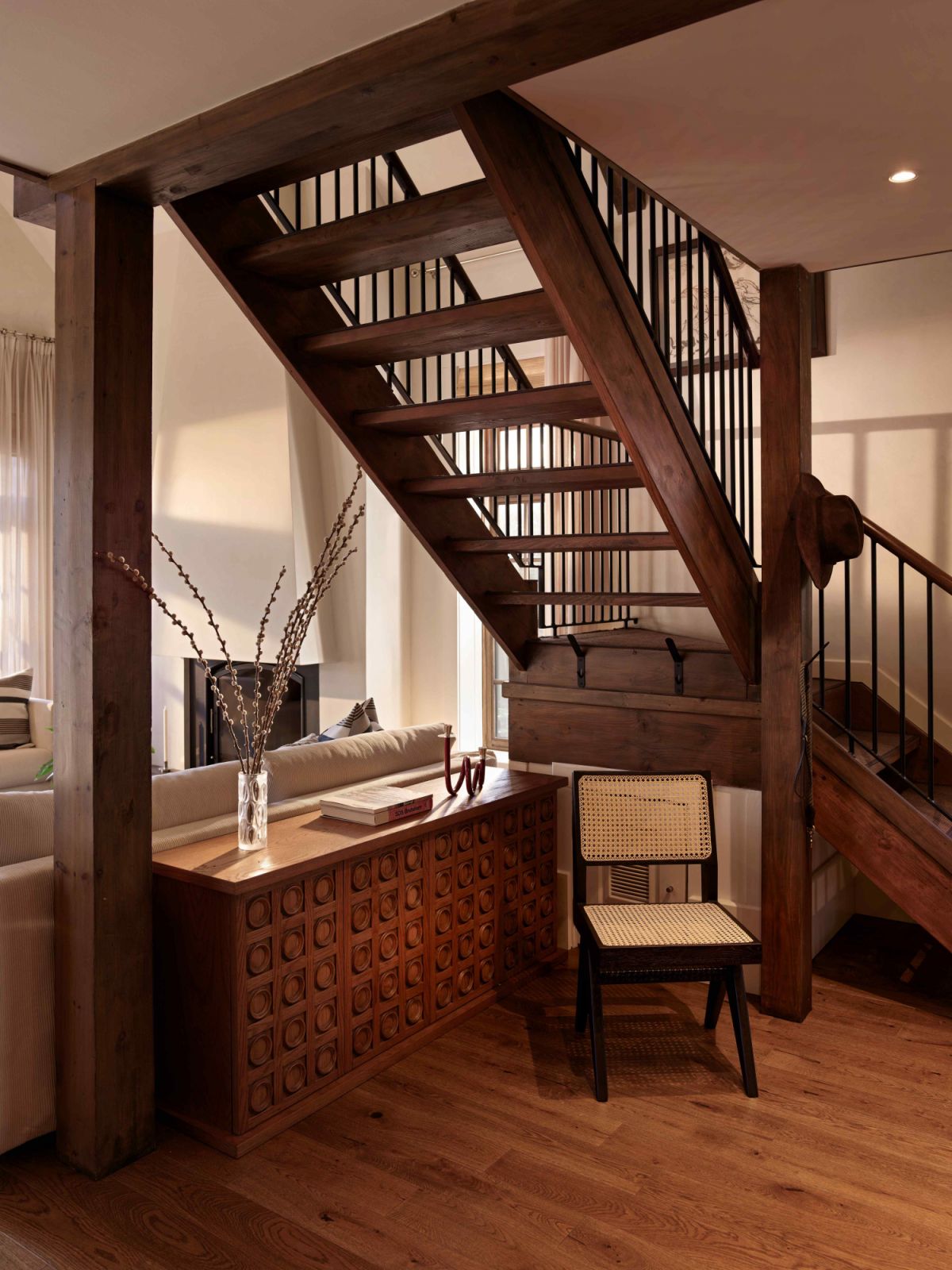 The wooden staircase contributes to the dynamic flow