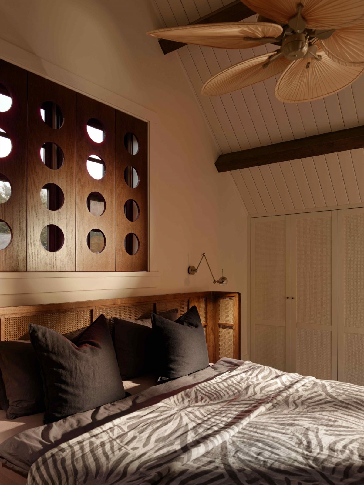 The master bedroom features a custom-designed wooden headboard