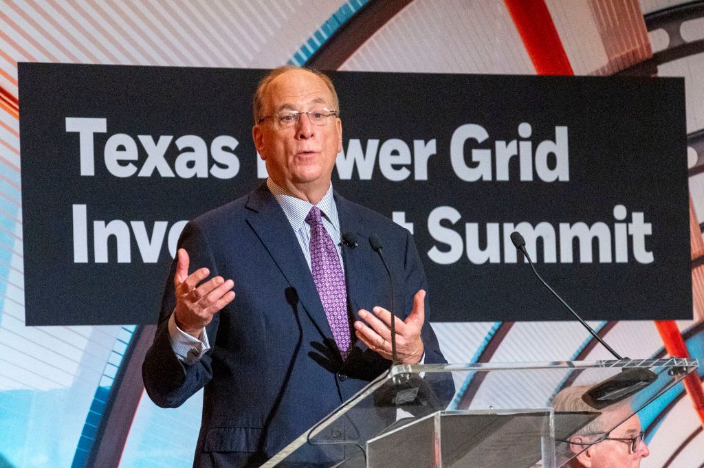HOUSTON, TEXAS - FEBRUARY 6: Lieutenant Governor Dan Patrick, right, listens as Larry Fink, Chairman and Chief Executive Officer of BlackRock, makes a statement during opening remarks of the Texas Power Grid Investment Summit, Tuesday, Feb. 6, 2024 in Houston. (Kirk Sides/Houston Chronicle via Getty Images)