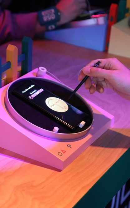 A visitor attempts the Digital Dalgona Challenge with a Samsung S Pen at the ‘Squid Game: The Trials” pop-up (Photo: Samsung)
