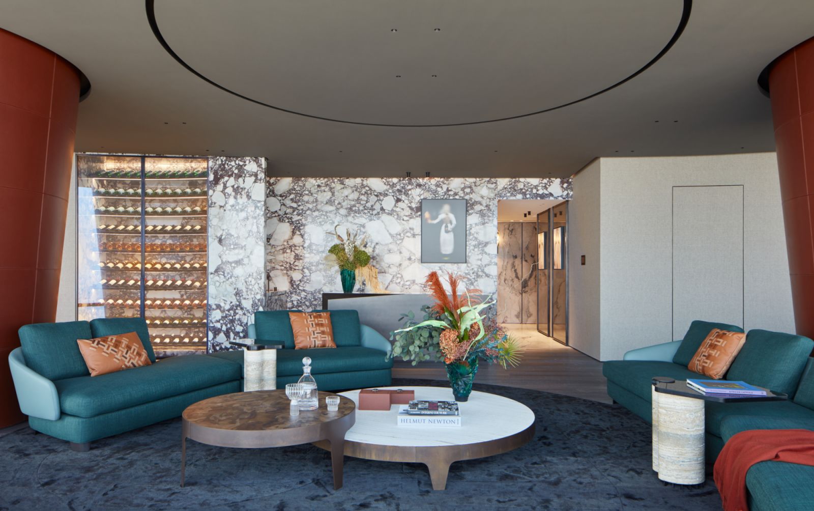 The living room of an exquisite jewel-toned apartment in Burj Khalifa with views of the Dubai skyline