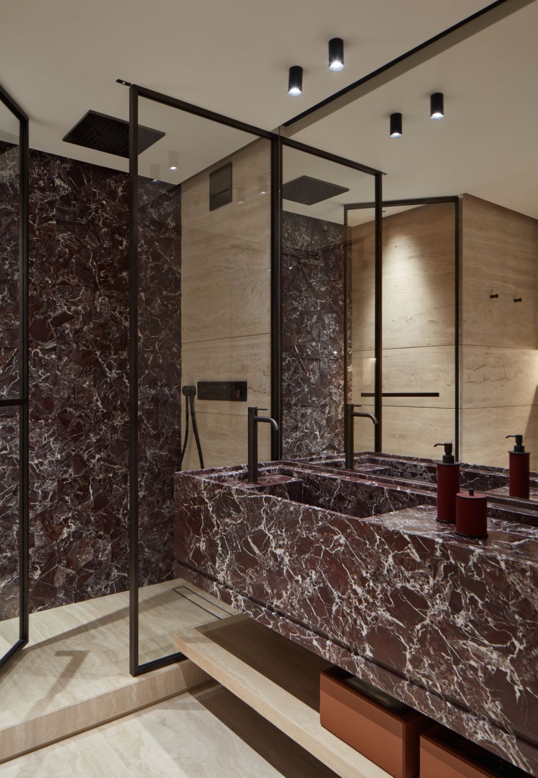 One of the bathrooms, with wine-red marble used in the sink and shower wall