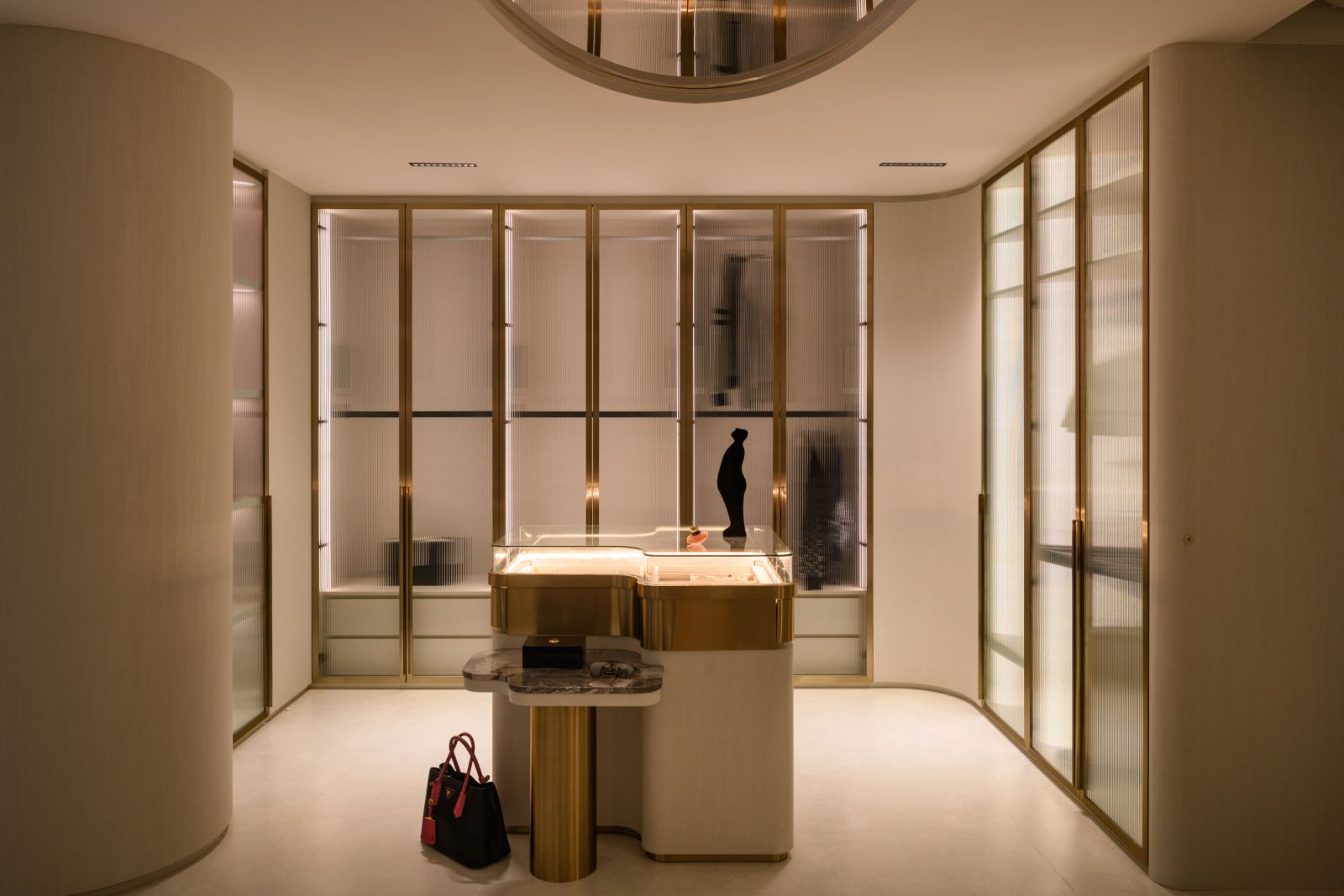 Taking cues from luxury retail design, the walk-in wardrobe features a dramatic mirrored ceiling that multiplies space and light