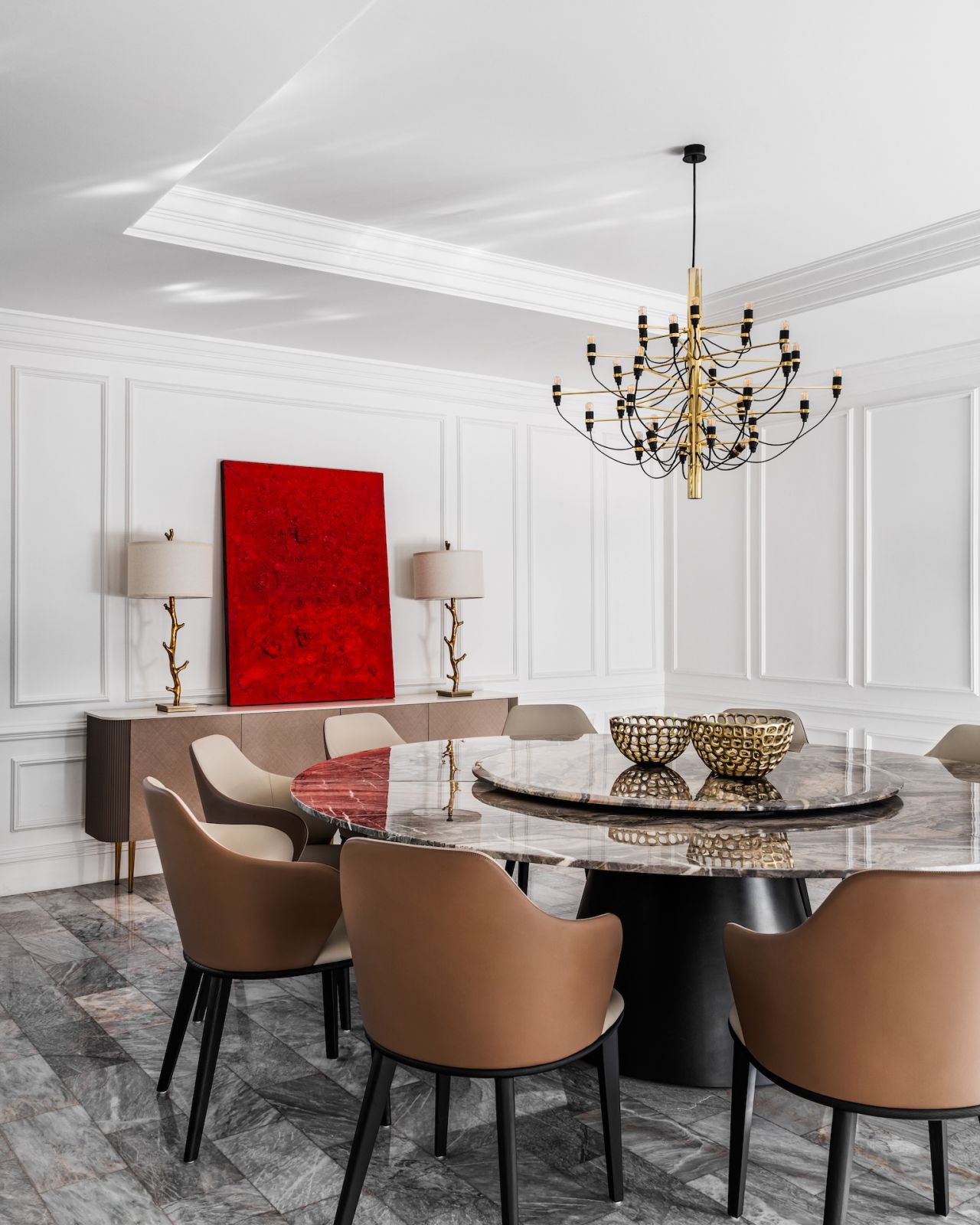 The neutral palette of the dining area, in contrast with a scarlet red artwork nearby