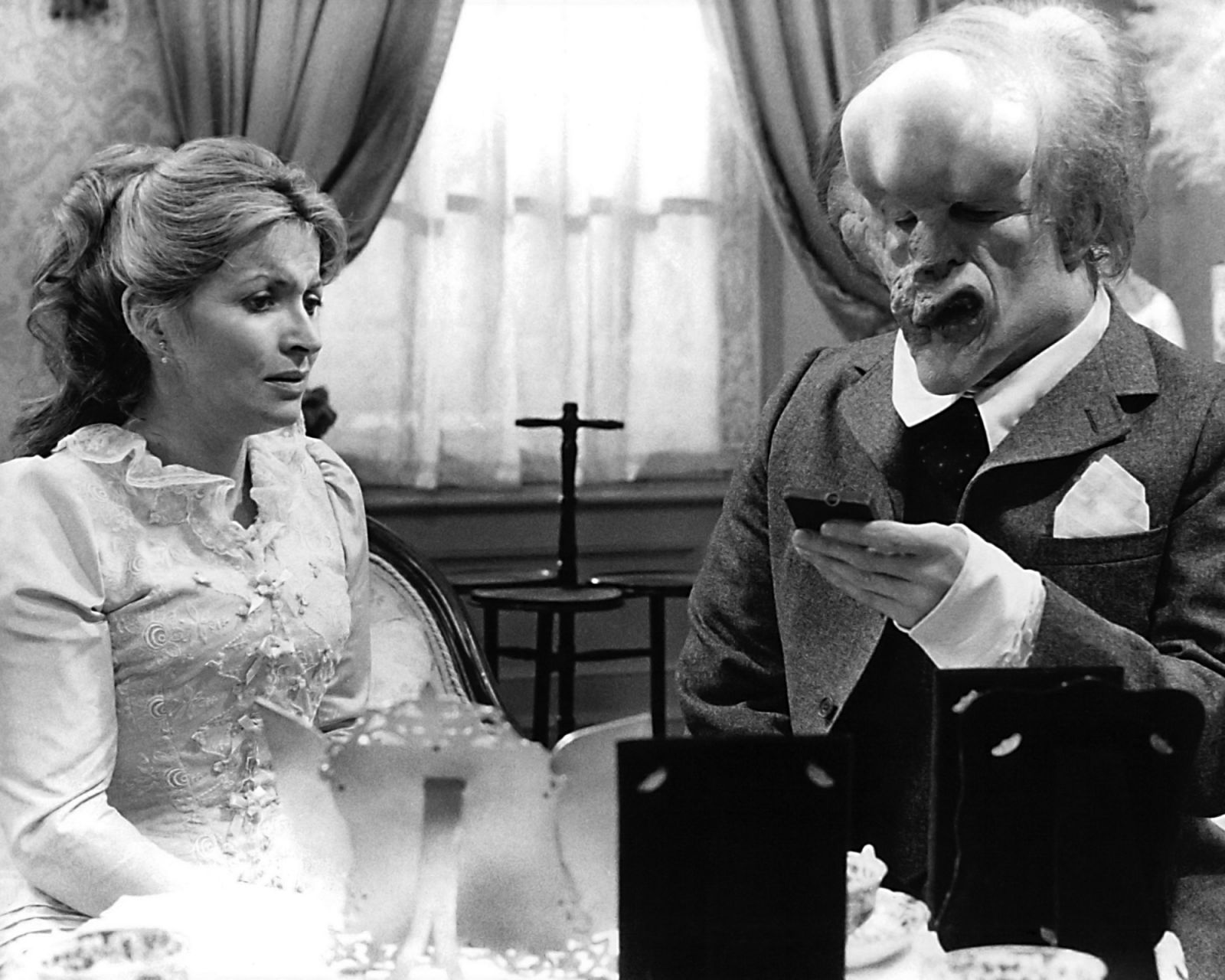 British actors John Hurt, as John Merrick, and Hannah Gordon as Ann Treves, in 'The Elephant Man', directed by David Lynch, 1980. (Photo by Silver Screen Collection/Getty Images)