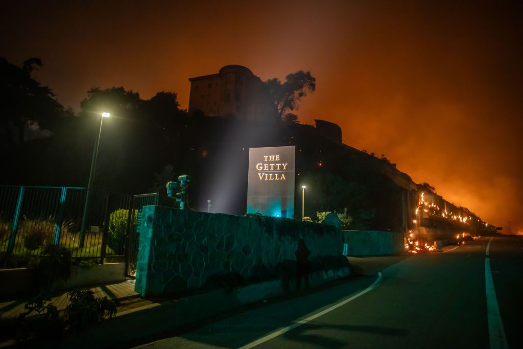 Flames from the Palisades Fire reach the grounds of the Getty Villa Museum on the Pacific Coast Highway amid a powerful windstorm on January 8, 2025 in Los Angeles, California (Photo by Apu Gomes/Getty Images)