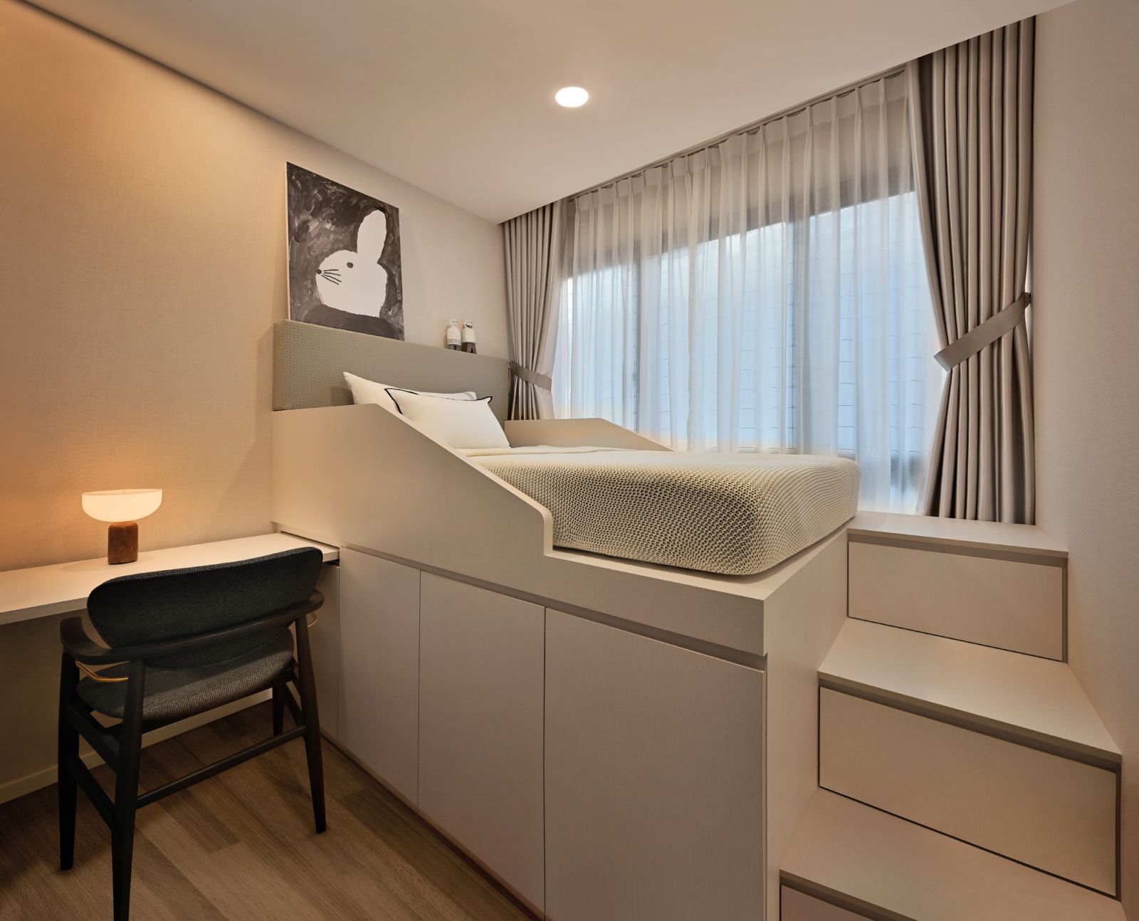 One of the children’s bedrooms features an elevated bed platform with a storage base and drawer steps