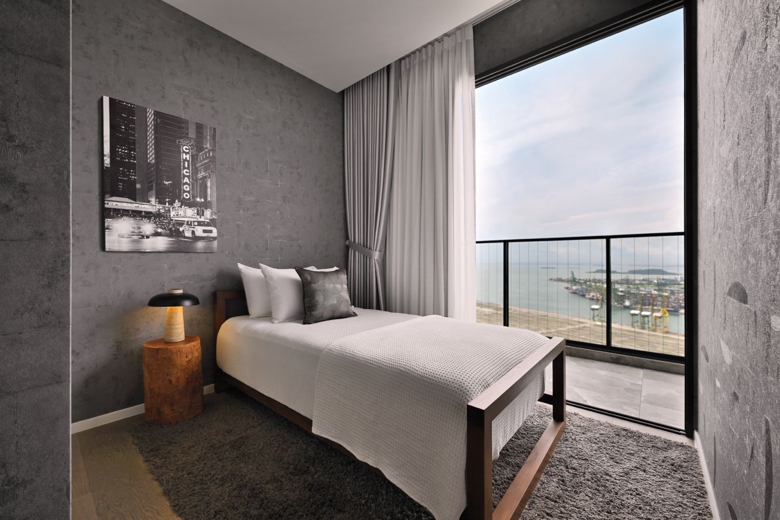This simple yet beautifully decorated common bedroom opens out to a balcony with sweeping views of the water