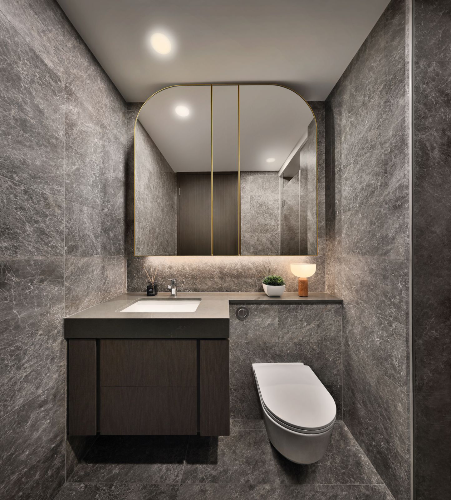 Charcoal-toned marble with subtle white veining adds a touch of class to this bathroom