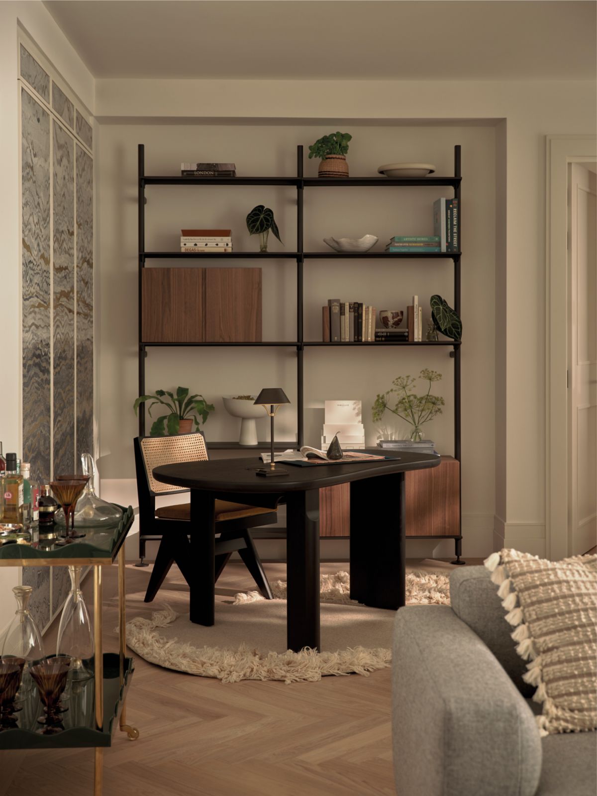 This nook’s handsome mid-century desk and woven-cane chair stand out with their dark finish