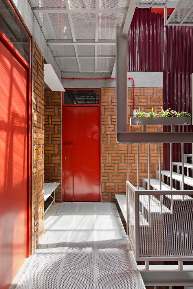 An interplay of the red metal walls and exposed brickwork (Photo: Instagram / @ismailsolehudinarchitecture)