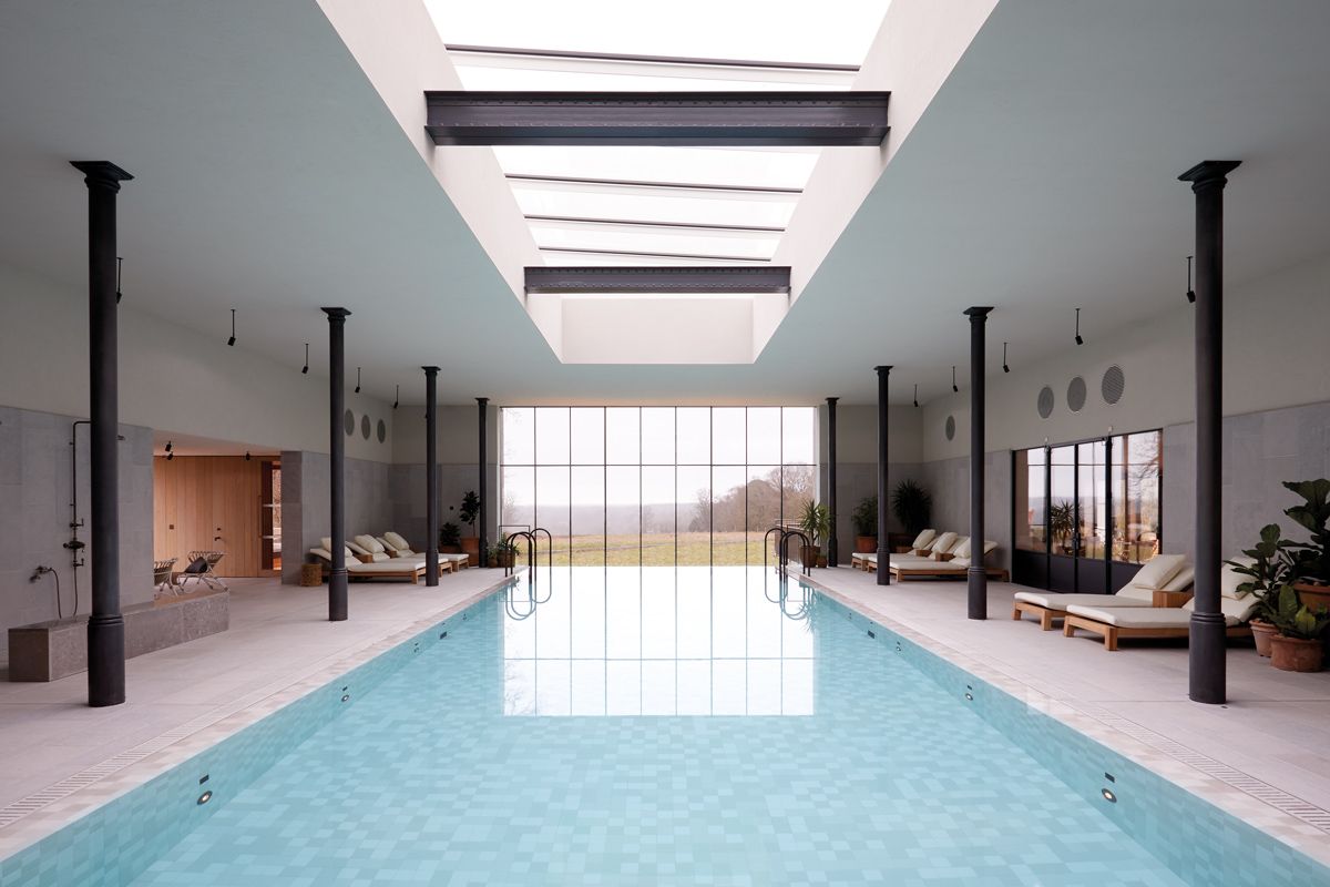 A view of the foggy English countryside from The Bothy by Wildsmith at Heckfield Place's heated pool area