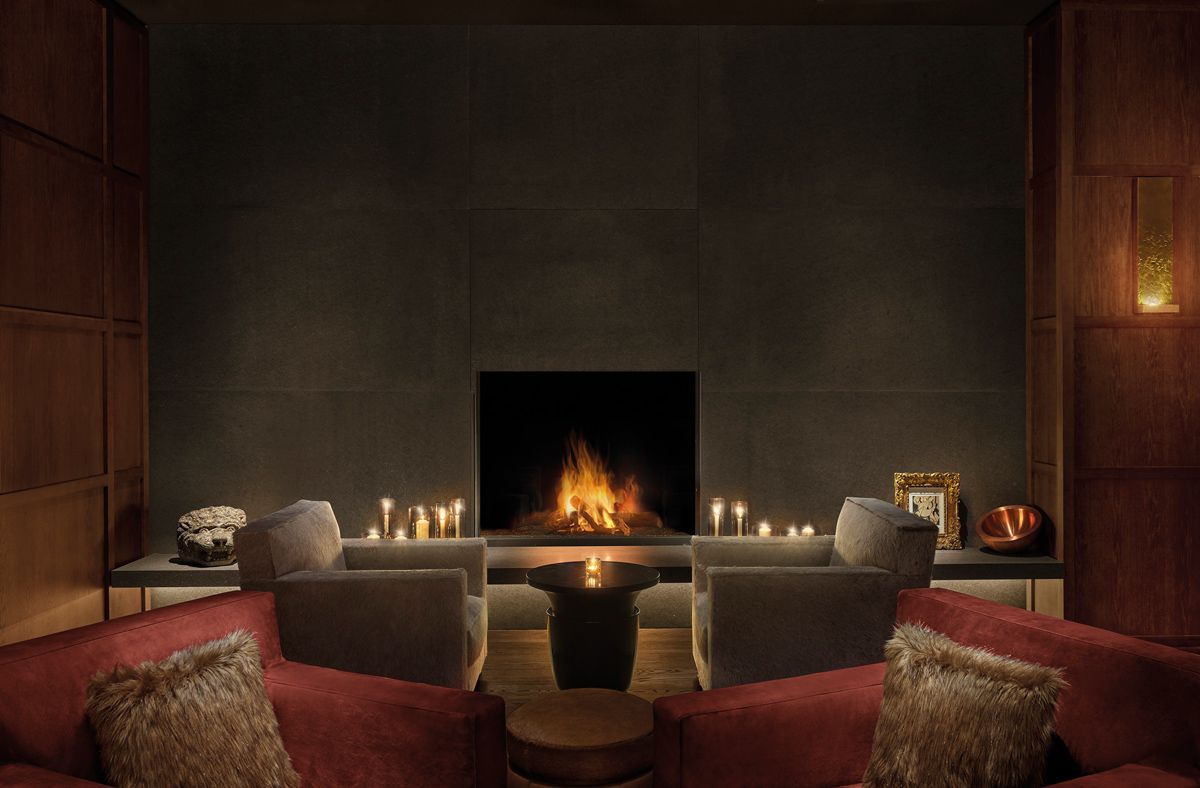 A cosy spa lounge with a fireplace at the Madrid Editon hotel
